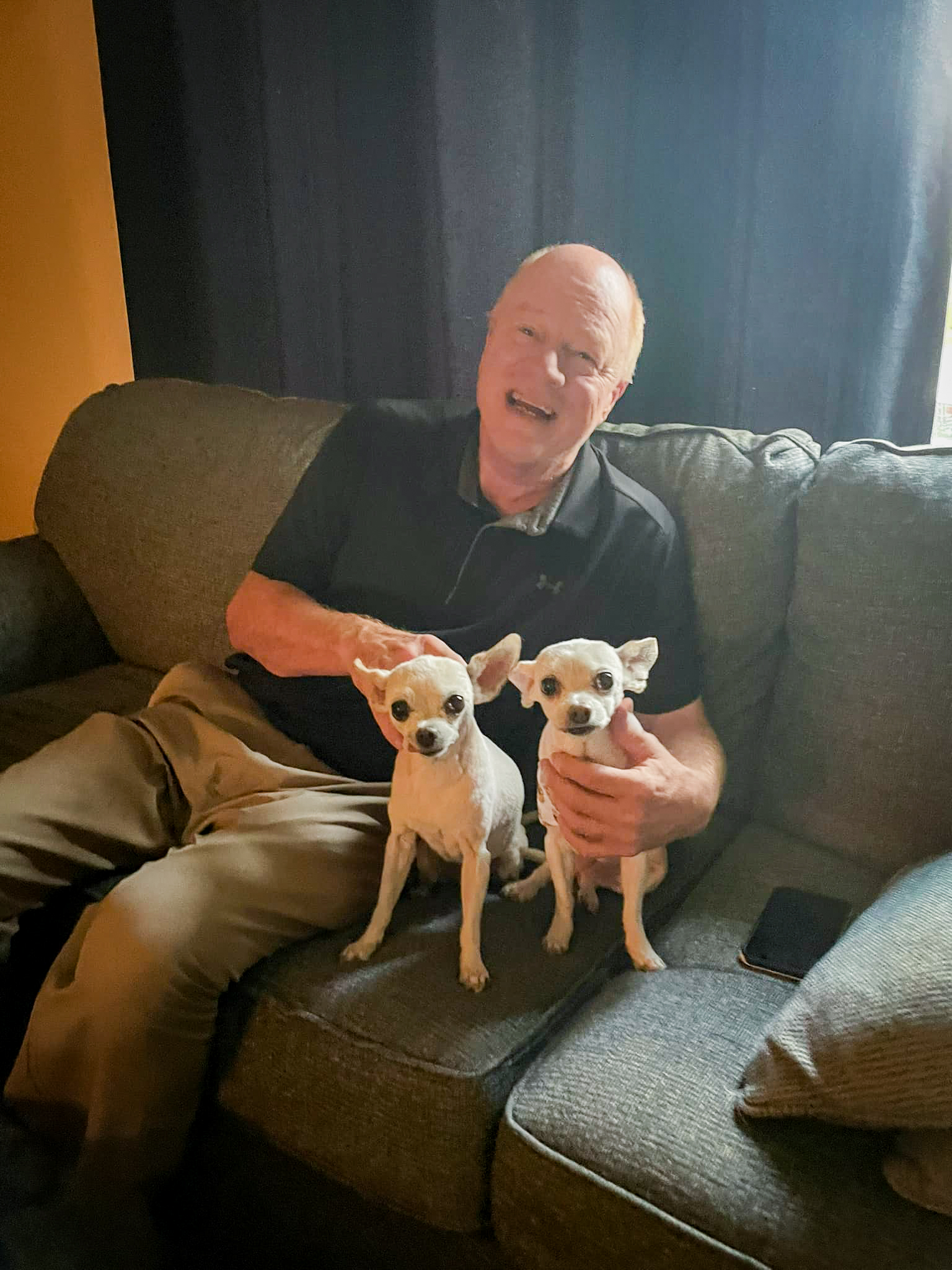Male sitting with two dogs