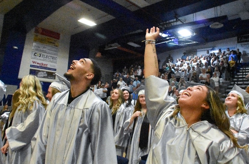 Image of two college students at graduation